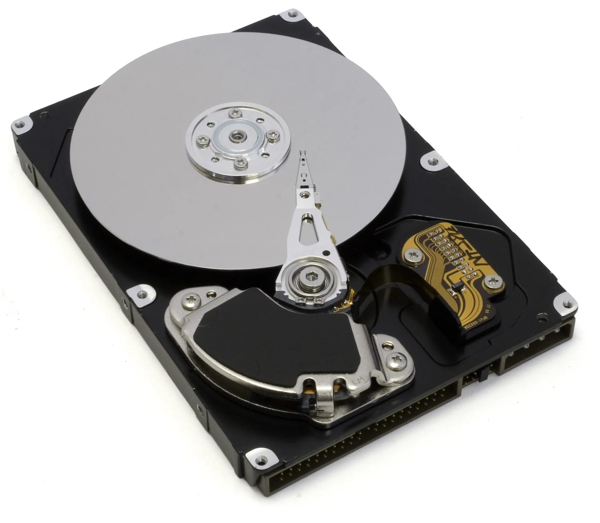 An open hard disk drive showing its circular platter and actuator arm