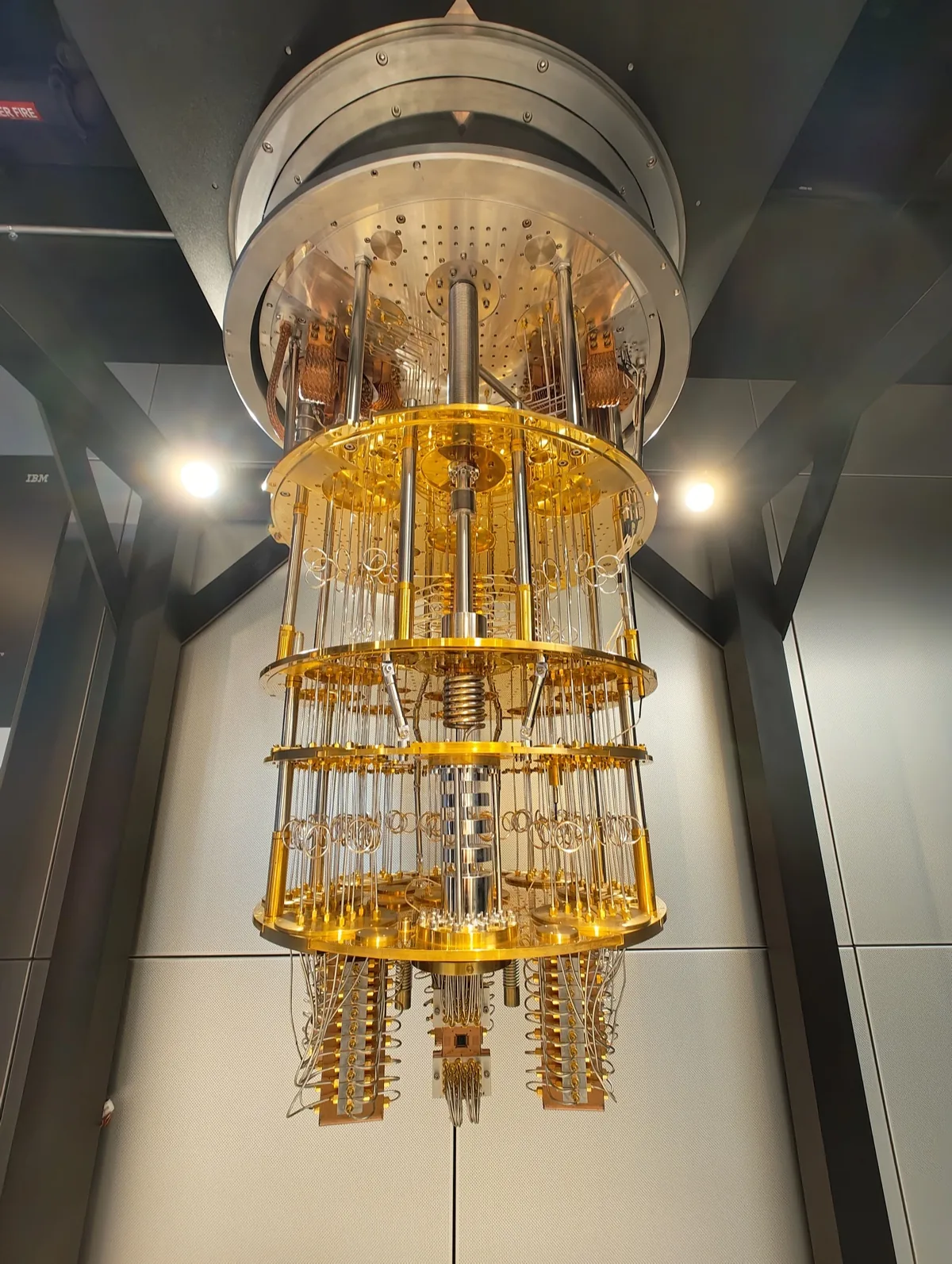 An IBM Quantum System One: a glass cube enclosing the cylindrical cryostat of a superconducting quantum computer